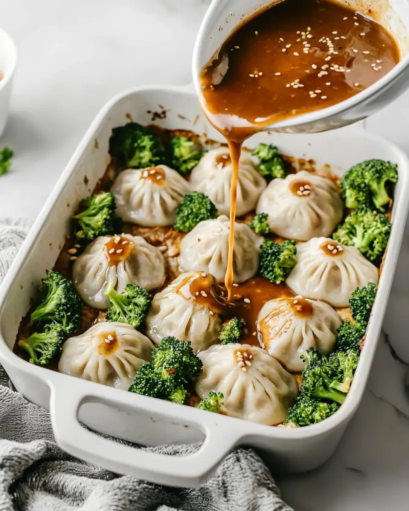 Oven-baked dumplings with peanut sauce and broccoli in a baking dish